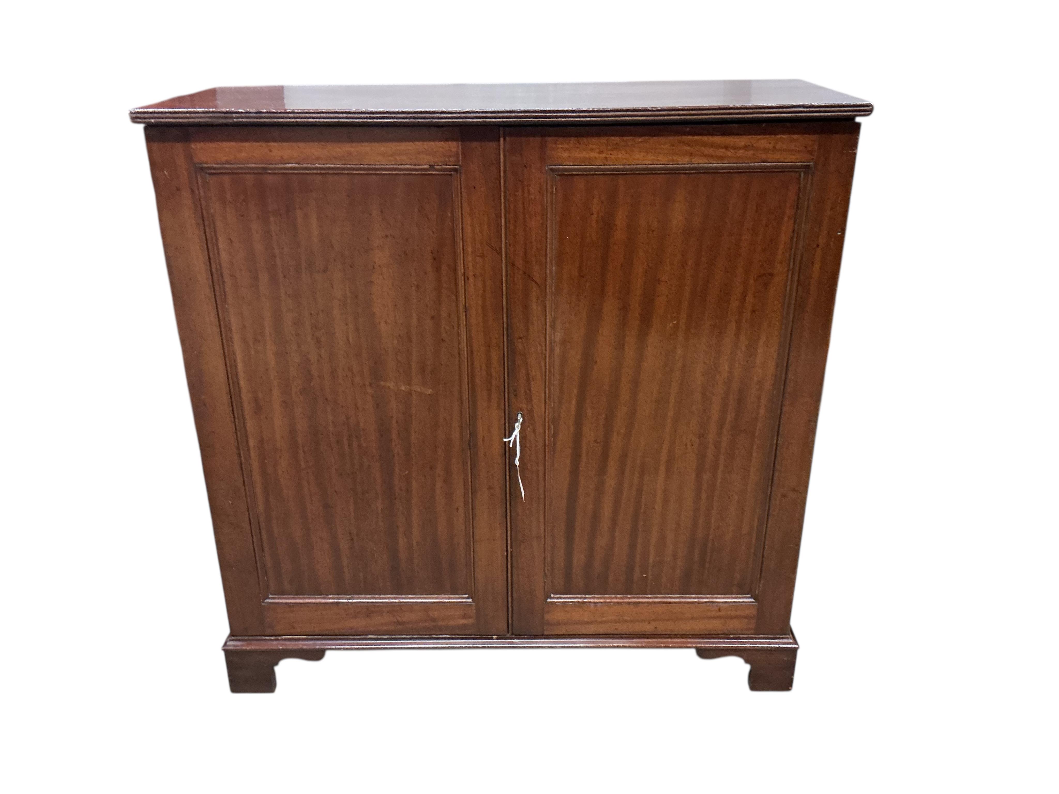 An early 19th century mahogany two door side cabinet, width 103cm, depth 37cm, height 104cm